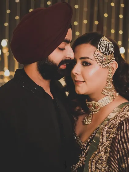 Another beautiful, intimate portrait of the couple. Their coordinated deep-toned outfits create a sophisticated and romantic vibe.