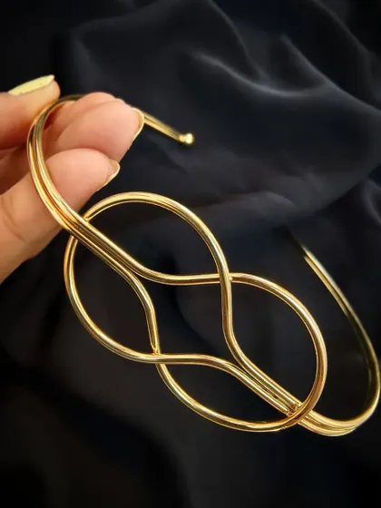 A close-up of the Layla Lotus gold Hasli statement neckpiece, showing the beautiful knot detail. It's anti-tarnish.