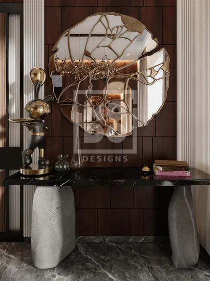A detail shot of the console table in the Dadar project. The combination of a stone base, black marble top, and sculptural mirror creates a stunning and artistic focal point.