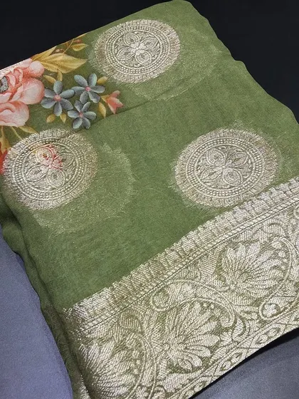 An elegant olive green saree in viscose fabric, featuring a lovely floral digital print and a classic zari border. This saree is perfect for both day and evening events.