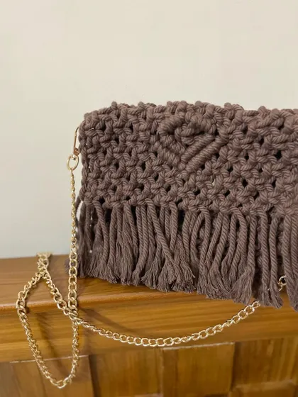 A close-up of the brown sling bag. You can see the heart pattern I've woven into the flap. It's all in the details!
