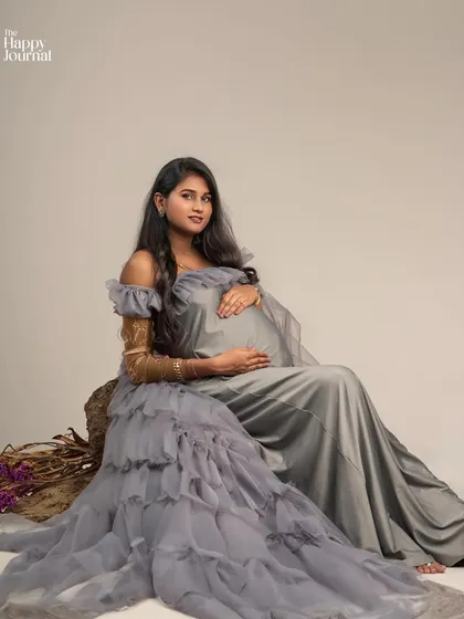 This seated portrait in the grey gown offers a different mood, feeling more intimate and gentle. The soft fabric drapes beautifully around her.