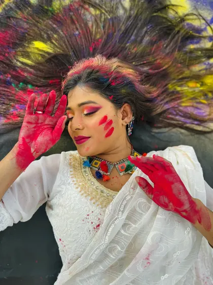 A beautiful and artistic shot celebrating the festival of Holi. The makeup is designed to complement the vibrant colors, creating a stunning visual.