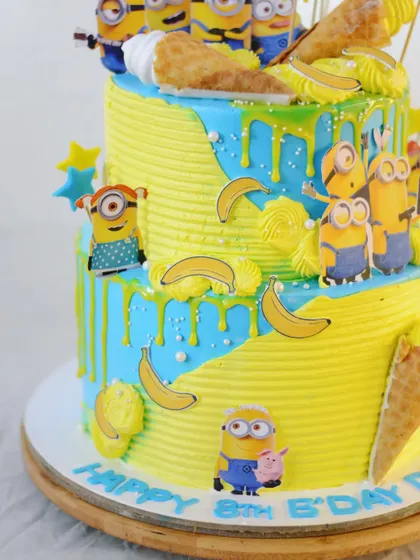 A side view showing the dripping blue ganache and the playful placement of the Minion characters.