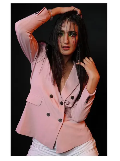 A creative portrait with wet hair and bold, colorful eye makeup. The dramatic lighting and intense expression give this shot a high-fashion, editorial edge.