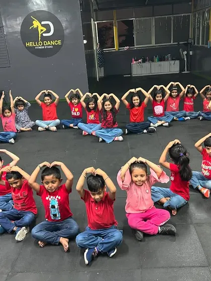 The kids' batch making heart signs with their hands, a gesture we love to share. It's our way of spreading the love and positivity that dance brings into our lives.
