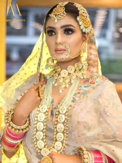 A stunning off-white jewellery set with coin-like details, paired with a matching lehenga. This is a unique and royal look for a bride who wants to stand out.