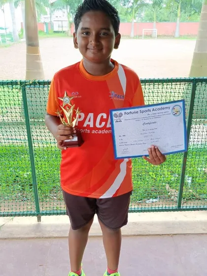 The Boys U10 winner poses with his trophy and certificate after a successful tournament. We manage events that serve as a crucial first step for young athletes in their competitive journey.
