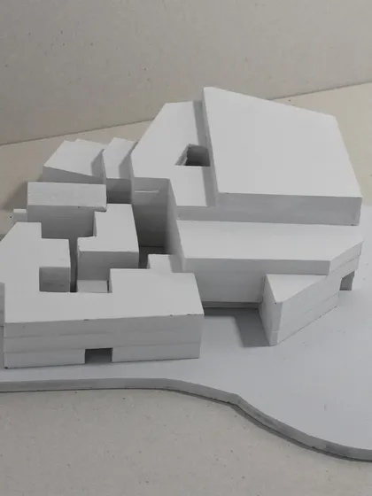 A conceptual massing model helps us explore the fundamental volumes and voids of a building. This abstract study is a critical early step in defining a project's form and its relationship to the site.