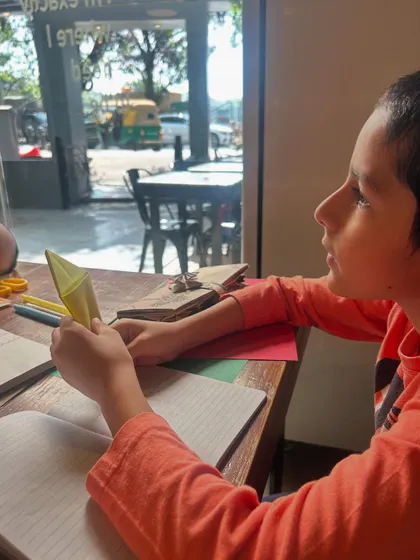 Look at the focus on this young learner's face as he works on his origami creation. This is what happens when we connect learning to something creative and tangible. He isn't just folding paper; he's exploring geometry, following a sequence, and practicing fine motor skills.