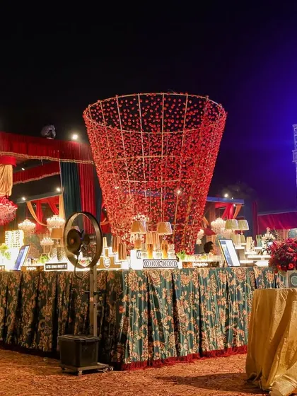 A view of the extensive buffet setup, featuring a large, artistic red centerpiece. Even functional areas are designed with aesthetic flair to maintain the immersive experience.