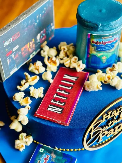 The perfect cake for a dad who loves to Netflix and chill. This fun design features an edible TV screen, popcorn, and his favorite pan masala for a truly personalized celebration.