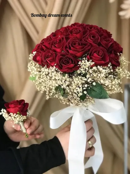 A classic bouquet of red roses surrounded by baby's breath, tied with a white ribbon. I also provide a matching boutonnière for the perfect couple's look.