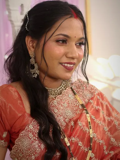 Another stunning close-up of the bride's reception look. The makeup enhances her features and gives her a sophisticated glow.