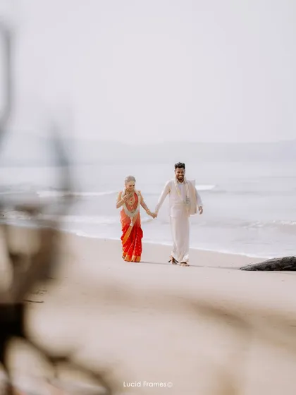 A wide shot of the couple walking on the beach, creating a sense of peace and solitude.