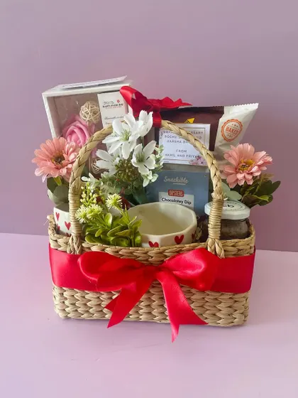 A Kauna basket hamper perfect for Valentine's Day or an anniversary. It's filled with heart-themed mugs, chocolates, and other romantic treats.