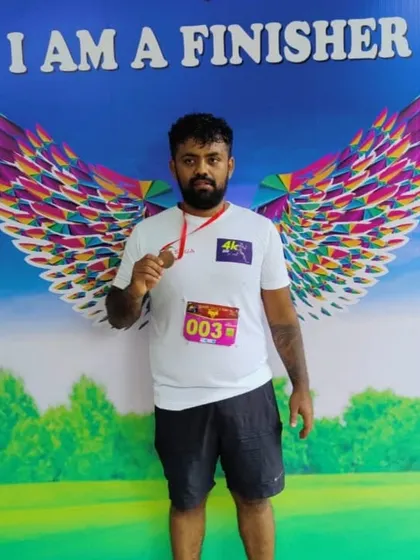 Our athlete after completing the 4K Human Rights Day Run. We encourage participation in community fitness events.