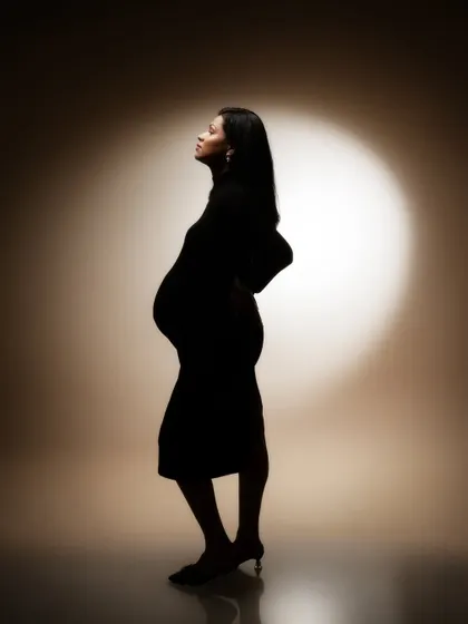A dance of light and shadows. This stunning silhouette shot is a story of motherhood, grace, and the delicate balance of light and shadows.
