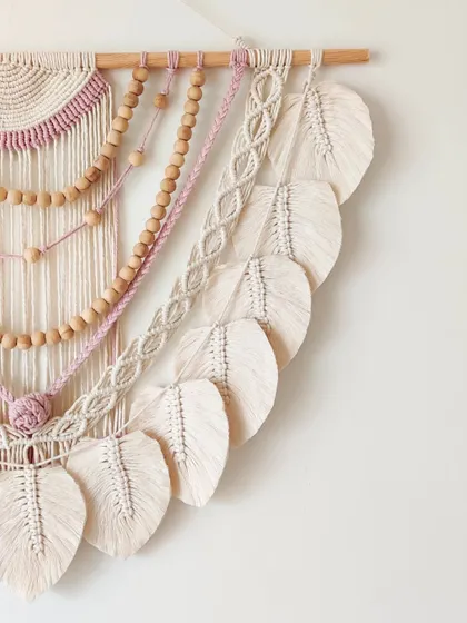 A close-up of the right side, showing the layers of beads, braids, and leaves.
