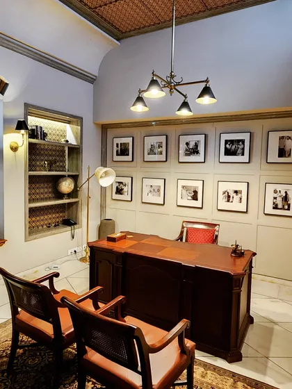 This home office, designed for a renovated bungalow in the Lutyens Delhi area, is a study in functional elegance. We created a gallery wall to celebrate the client's personal journey, paired with classic wooden furniture and carefully selected lighting to build a sophisticated and inspiring work ambiance.