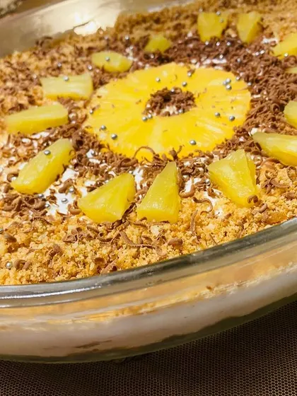 A beautiful presentation of my Pineapple Delight, decorated with a pineapple ring and silver sprinkles.