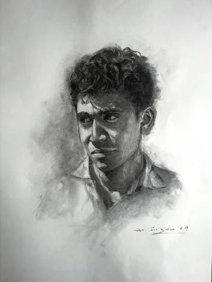 This charcoal portrait captures a moment of quiet contemplation. The strong contrast between the dark, shaded background and the brightly lit side of his face creates a dramatic, focused effect.