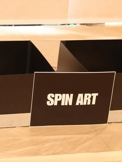 The setup for our popular Spin Art activity. We provide all the materials, including the spinning machines and paints, for kids to explore physics and art.