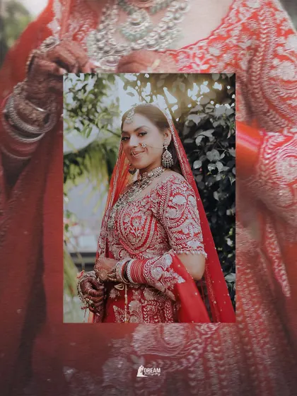 A beautiful, sun-kissed portrait of bride Hashmeeta, her smile and traditional red attire looking absolutely radiant.