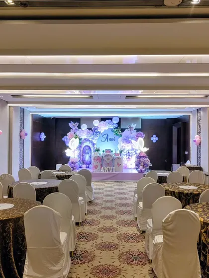 A wide view of the venue for the fairy-themed party, showing the guest seating arrangement.
