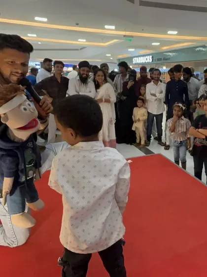 A candid moment with a young fan on stage at Inorbit Mall. These interactions make every show special and memorable for the audience.