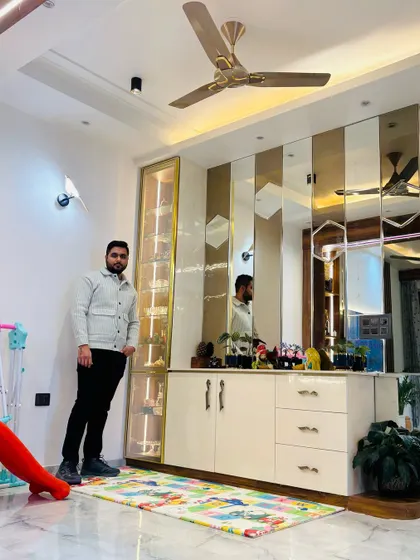 A look at a custom-built storage and display unit. This piece features a mirrored back panel to make the space feel larger, along with a combination of open and closed storage.