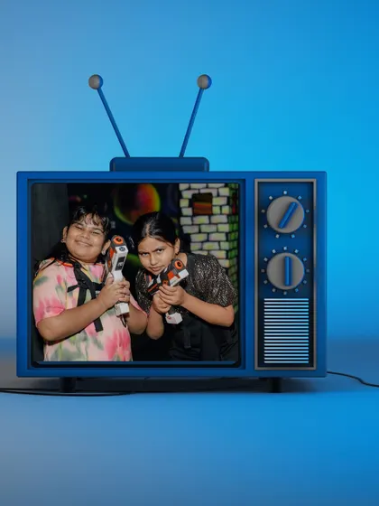 A snapshot of two friends teaming up for a laser tag match, ready to take on the competition together.
