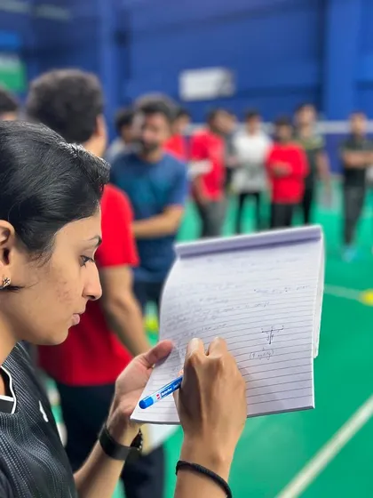 A participant in my Coaches Certification Program diligently takes notes during an on-court demonstration. I encourage a detailed approach to learning, as the small details often make the biggest difference in a player's development.