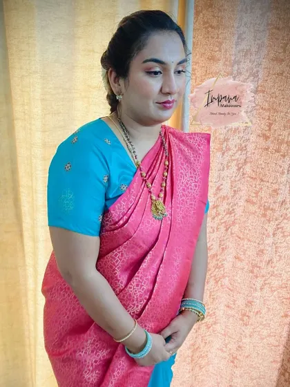 A traditional look for this client attending a wedding. The makeup is soft and pretty, paired with a classic hairstyle and saree draping.