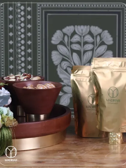 This image shows the complete gourmet dry fruit set, including the wooden platter and our custom-branded Madihah Gourmet pouches, ensuring a premium experience from presentation to taste.