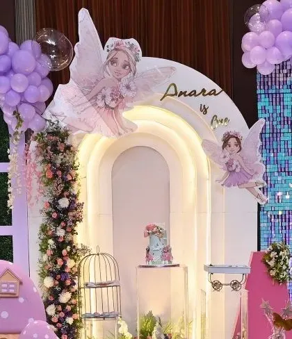 A full view of 'Anara's Onderland' birthday setup. The combination of a sequin wall, lighted arches, and whimsical props creates a truly magical atmosphere.