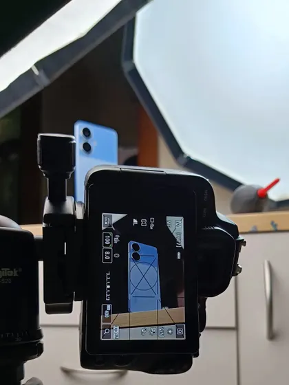 The camera and lighting setup for the blue realme Narzo product shoot, as seen from the camera's perspective.