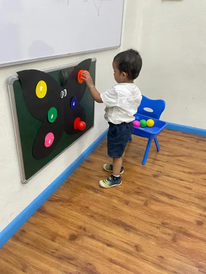 This little one is carefully selecting the right color for the butterfly's wing. This simple game is a powerful tool for developing cognitive skills like matching and sorting.