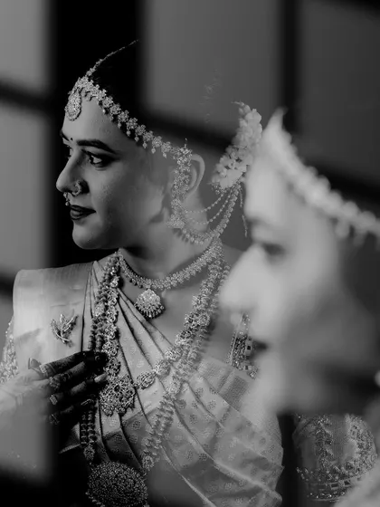 The same reflective black and white portrait, a powerful image that speaks to the bride's inner world on her wedding day.