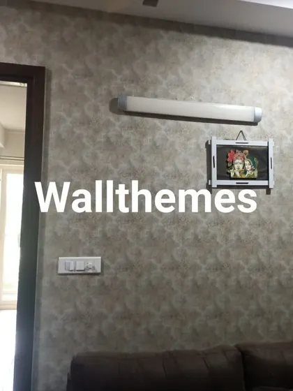 A subtle, textured wallpaper in a neutral tone installed in a living room, adding depth without overwhelming the space.