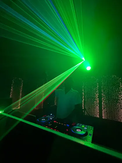 The club atmosphere is all about the lights and the bass. Here's a shot of me surrounded by green laser beams, setting the mood for a long night of dancing.