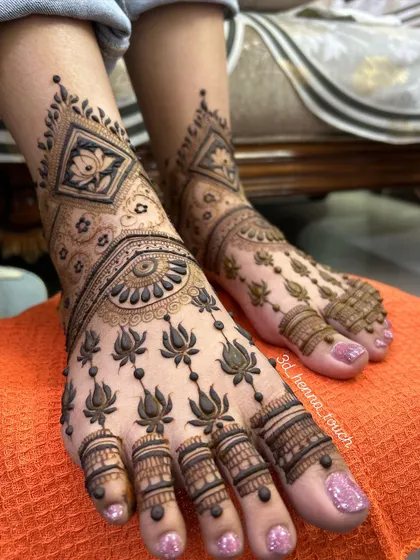 A beautiful bridal foot design featuring lotus motifs. The pattern is dense and intricate, covering the entire foot for a stunning bridal look.