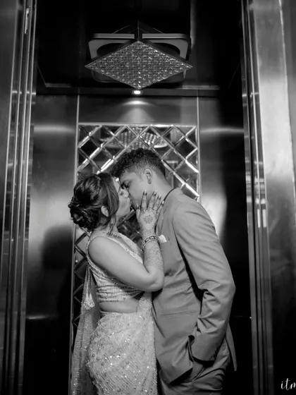 An intimate kiss in an elevator, captured in dramatic black and white. This unique and stylish shot turns a simple moment into a memorable, cinematic portrait.