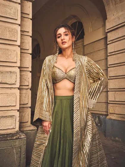 A full-length view that showcases the entire ensemble. The combination of the bralette, skirt, and jacket creates a layered, dynamic, and fashion-forward ethnic look.