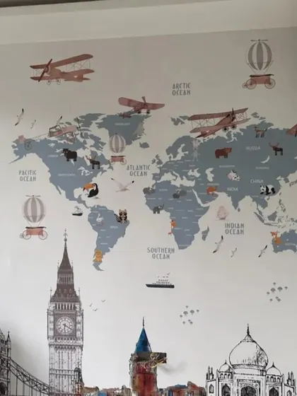 An educational and stylish world map wallpaper featuring famous landmarks, perfect for a curious young explorer's room.