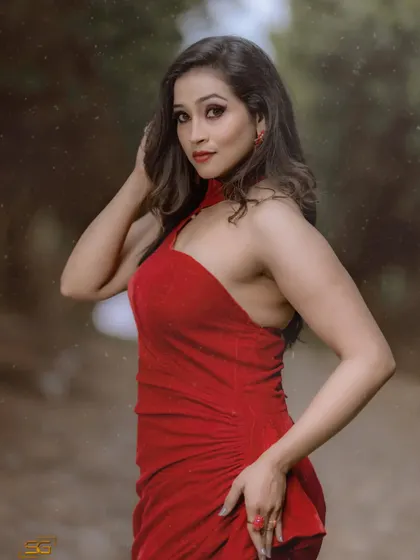 A model looking stunning in a red halter-neck gown with a high slit. This is one of my most popular rental dresses for its bold color and flattering fit.