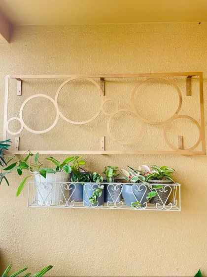 This decorative metal frame and simple wire rack were perfect for adding greenery to the wall without overwhelming the space. It’s a great way to display a collection of smaller plants.