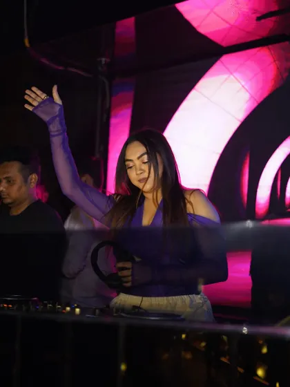 Reaching for the sky, a powerful pose during a live set.