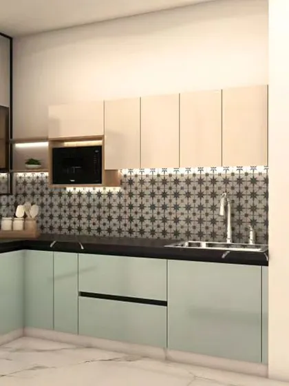 This kitchen design features handleless cabinets in light green and white, with a patterned tile backsplash adding visual interest. The layout includes dedicated space for a large refrigerator and other appliances.