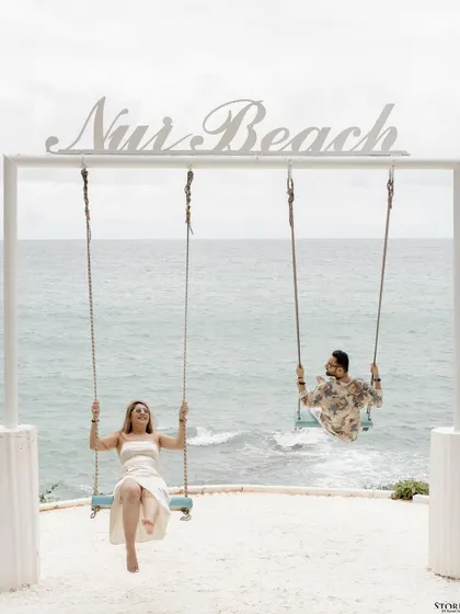 A playful and iconic shot at Nui Beach in Phuket. This image captures the fun and carefree spirit of a destination pre-wedding shoot.